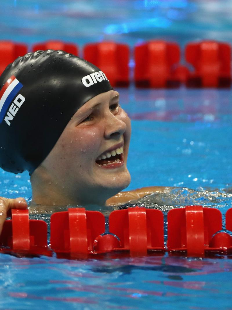 a female Para swimmer smiles in the pool