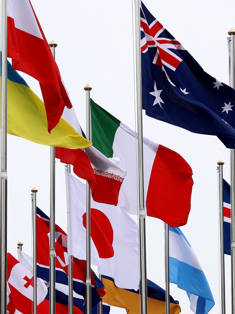 flags from many countries flying in the wind at the Paralympic Village