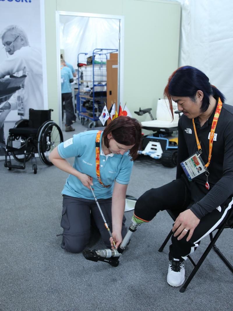 a woman works at repairing a prosthetic leg