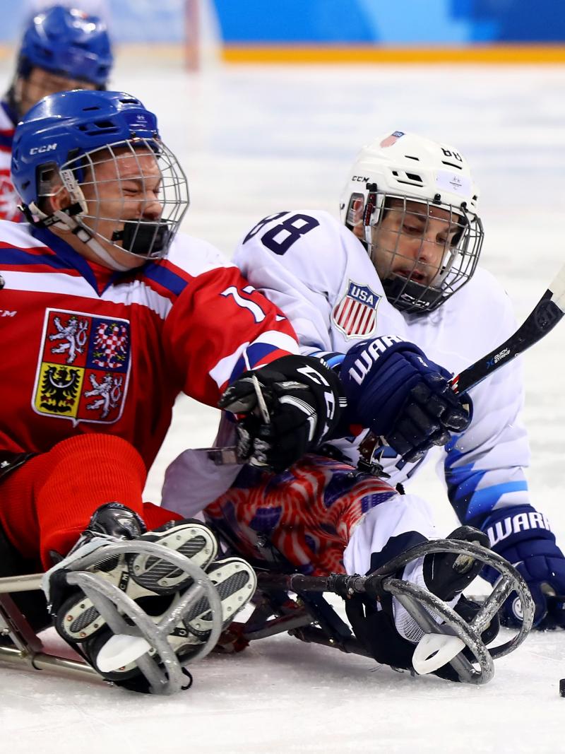 two Para ice hockey players clash on the ice