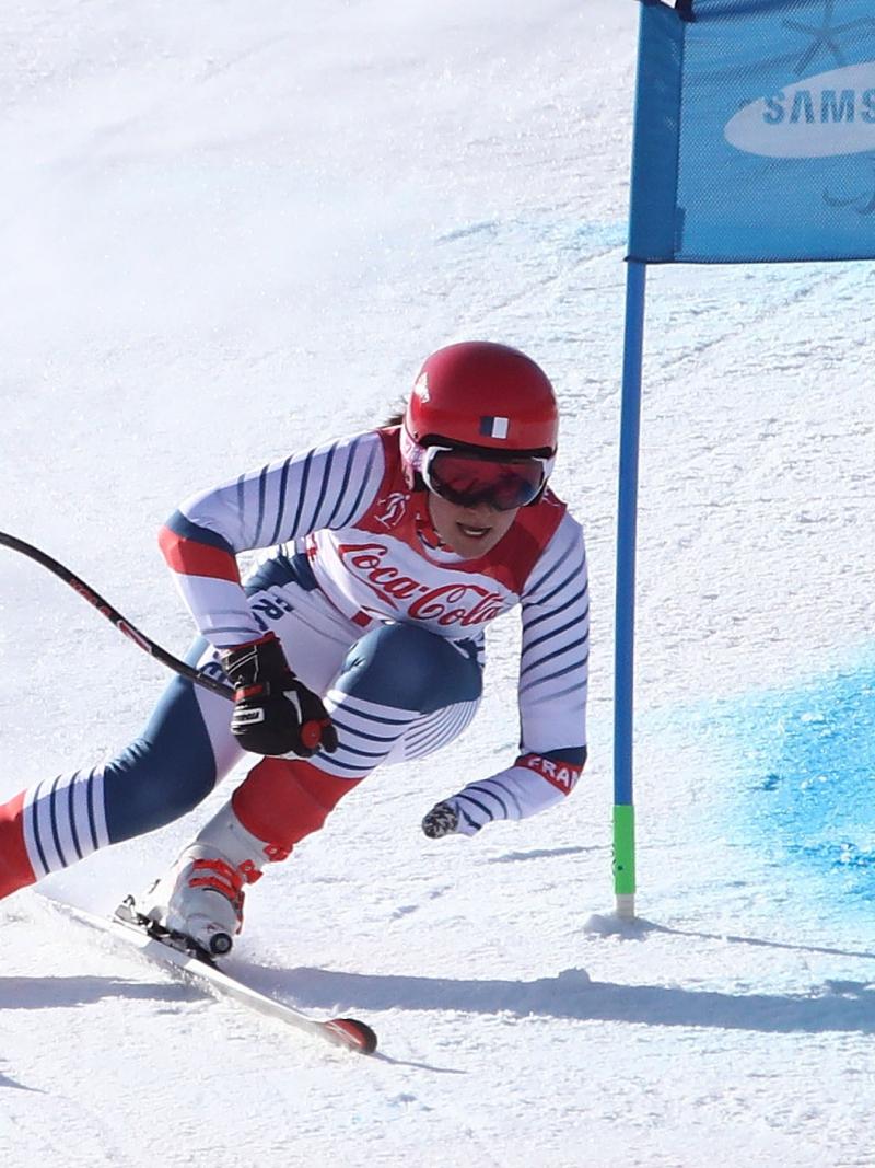 a female Para skier rounds a gate