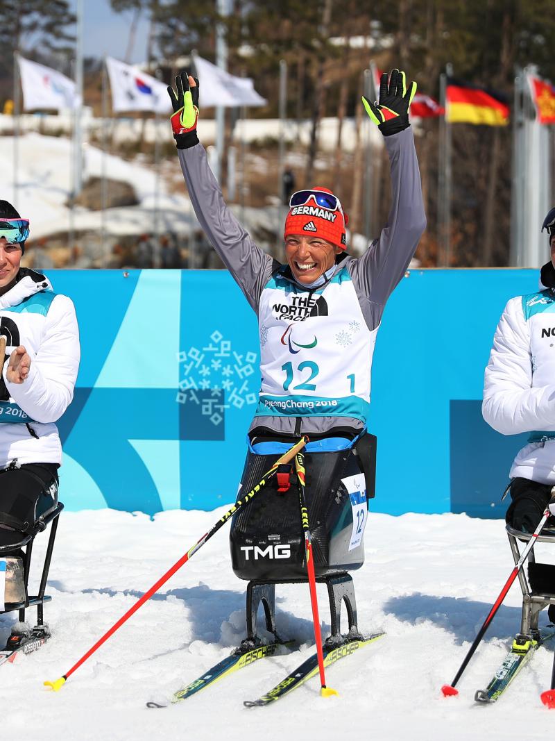 Germany's Andrea Eskau celebrates victory in the women's biathlon 10km sitting at PyeongChang 2018 with silver medallist Neutral Paralympic Athlete Marta Zainullina on the left and bronze medallist Neutral Paralympic Athlete Irina Gulaeva on the right.