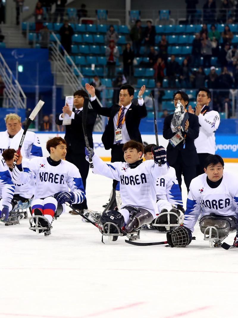 a group of Para ice hockey players on the ice