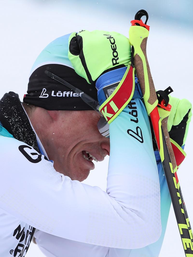 a male sit skier cries on the finish line