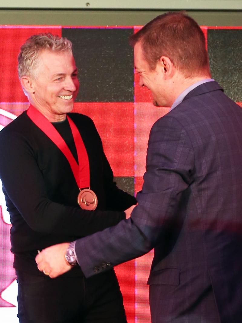 two men shaking hands and smiling