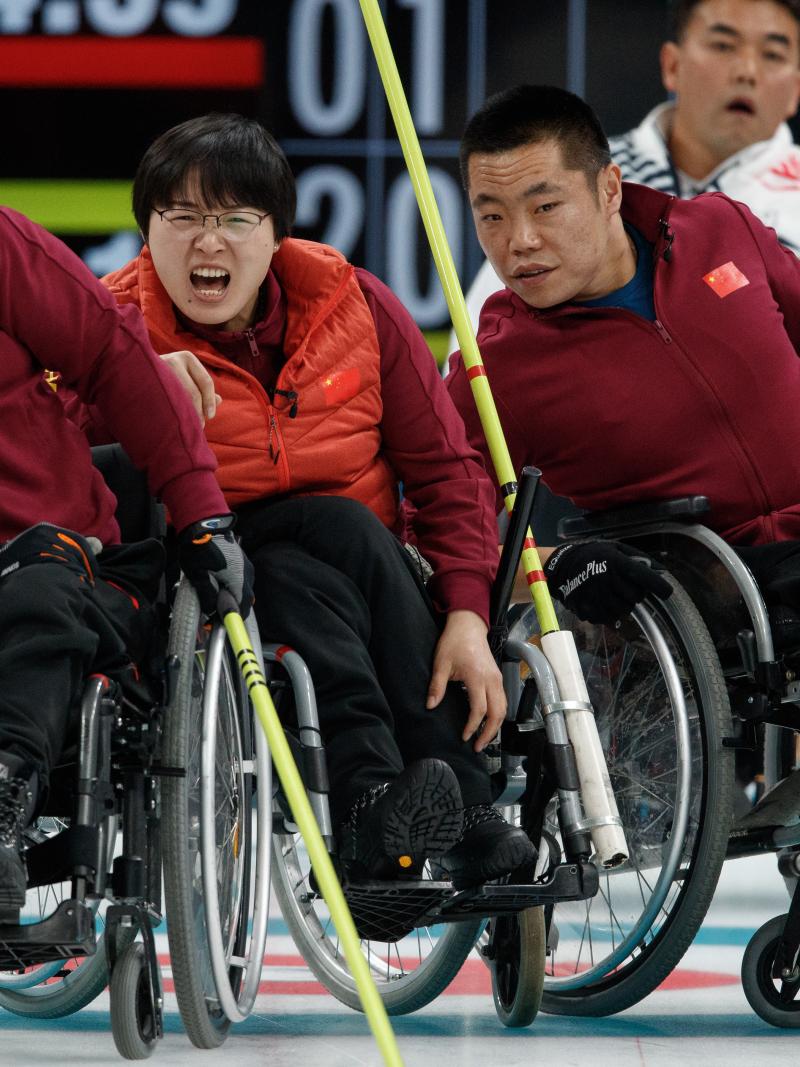 wheelchair curlers watching a stone