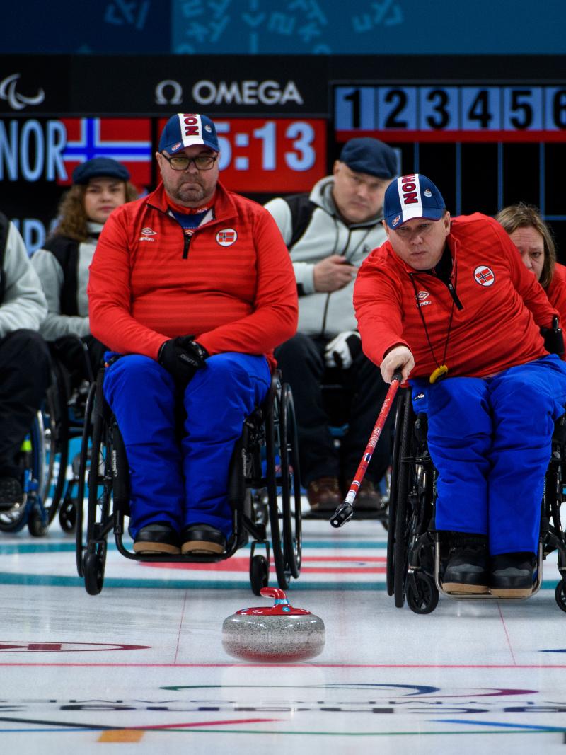 a wheelchair curler plays a stone