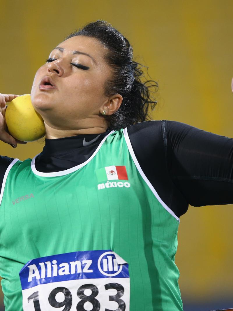 a female shot putter prepares to throw