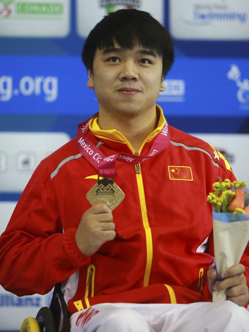 a male Para swimmer on the podium