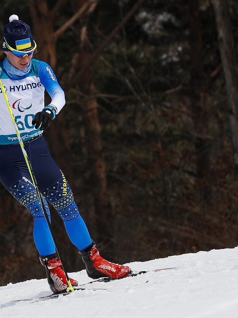 a female standing Nordic skier