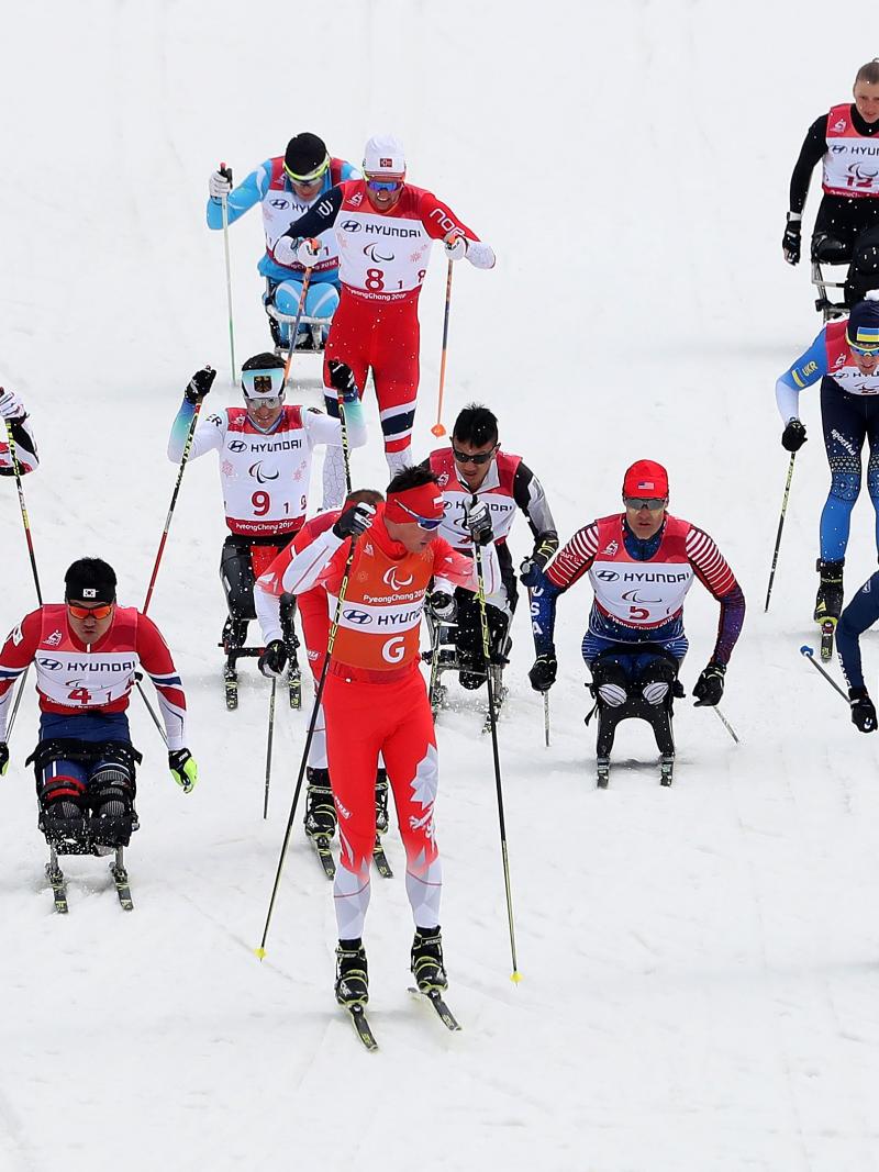 a group of cross-country skiers sprint for the finish line
