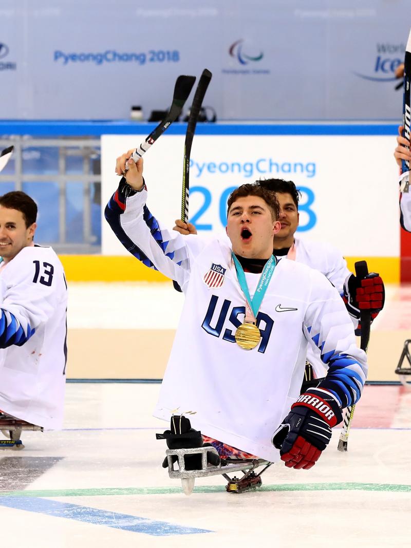 Para ice hockey players celebrating on the ice