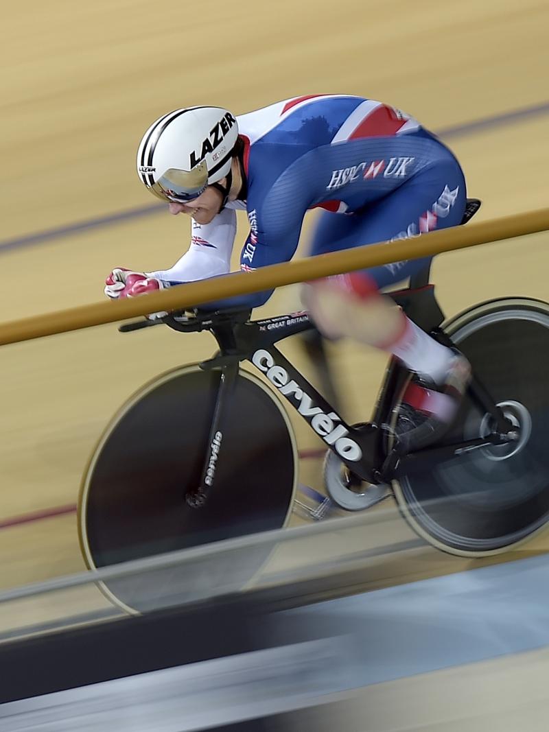 a male Para cyclist racing around a track