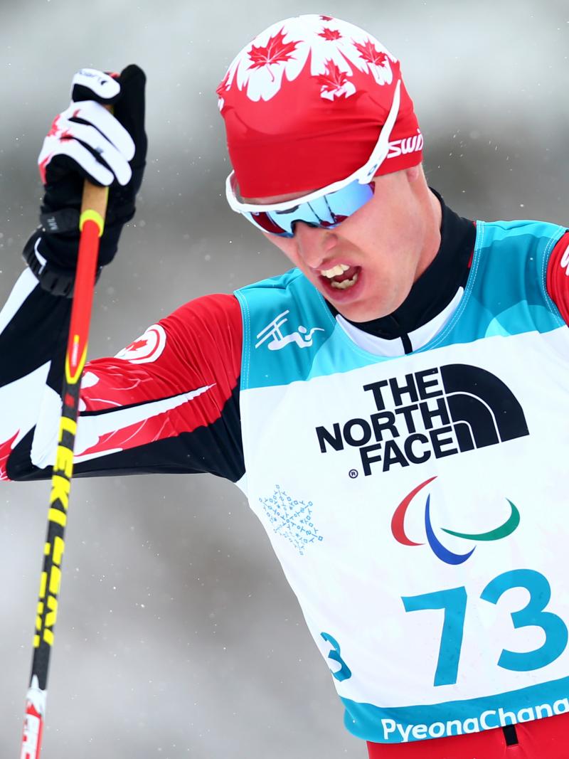 a male Para Nordic skier ploughs through the snow