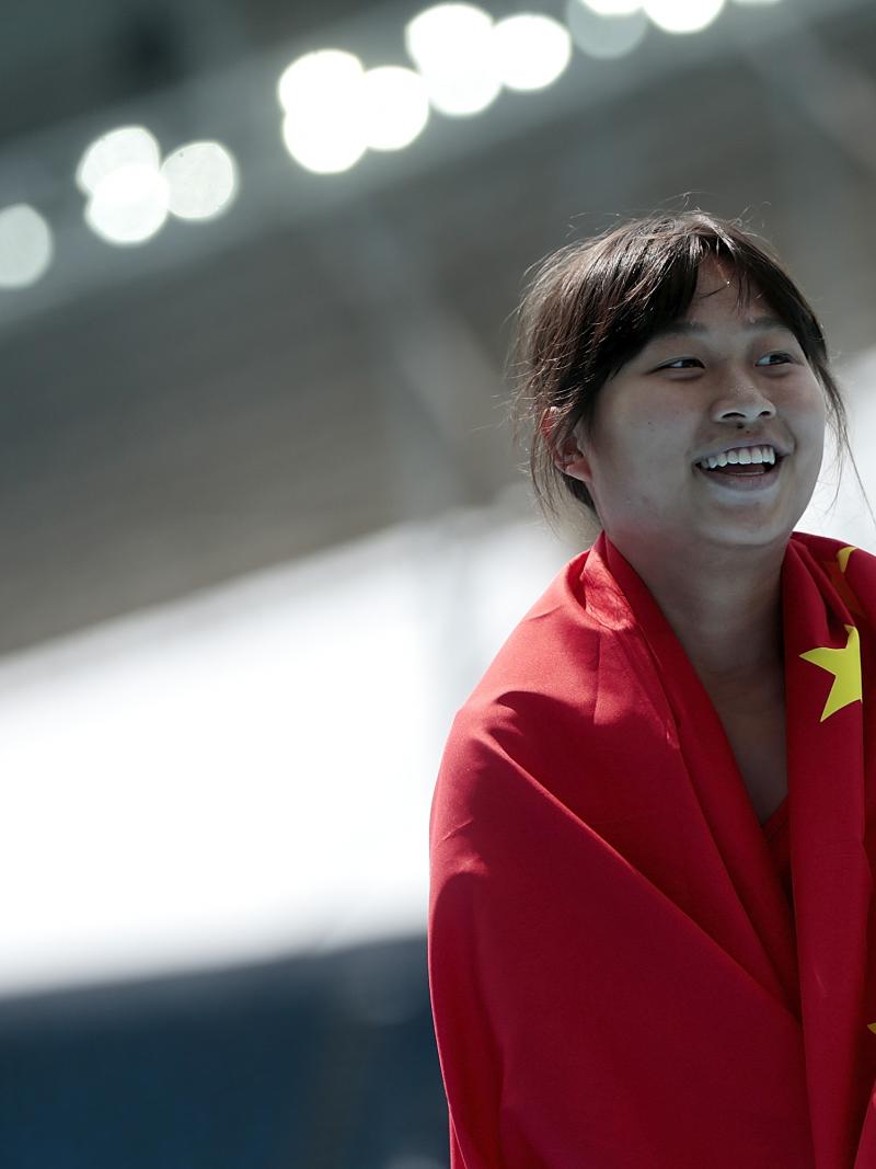 a female Para athlete wrapped in the Chinese flag
