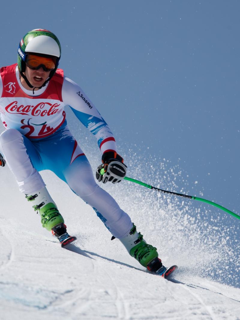 a male standing Para alpine skier in action