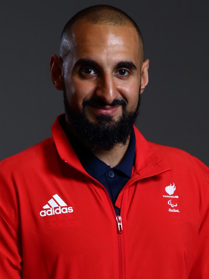 a male powerlifter smiles for the camera