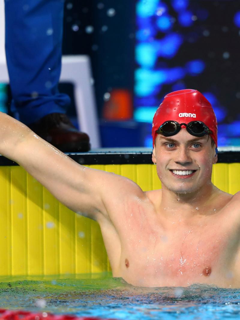 a male Para swimmer celebrates his win in the pool