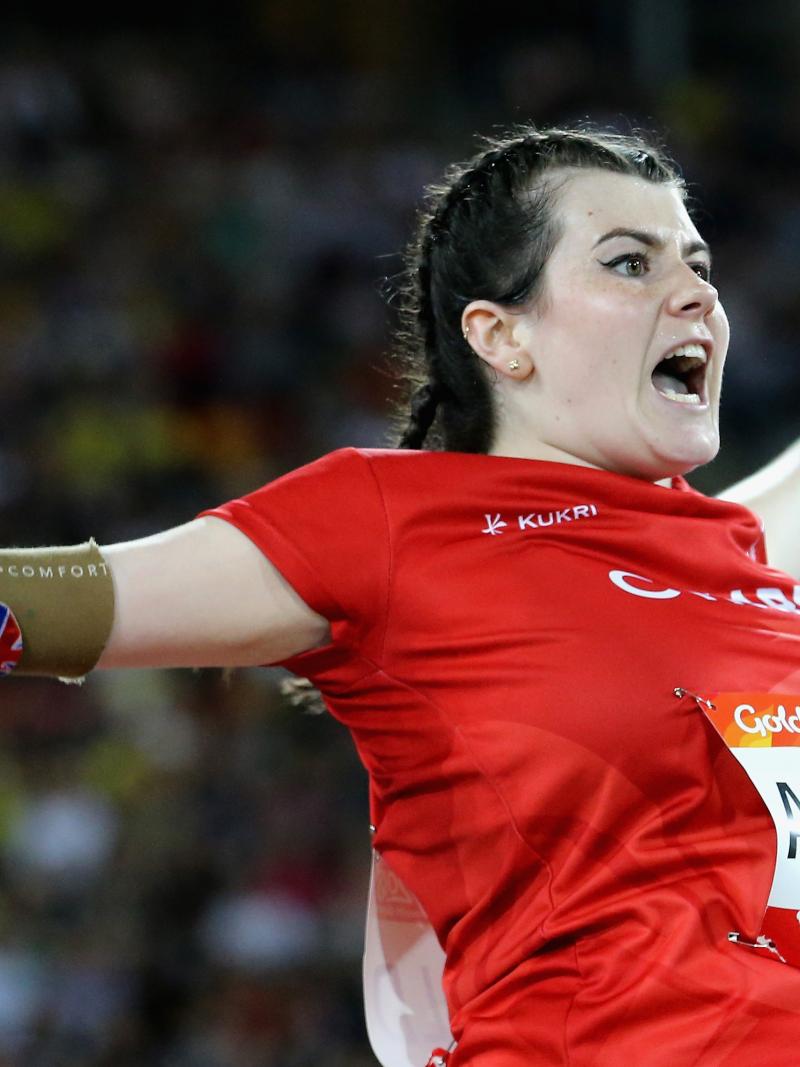a female thrower screams as she throws her javelin
