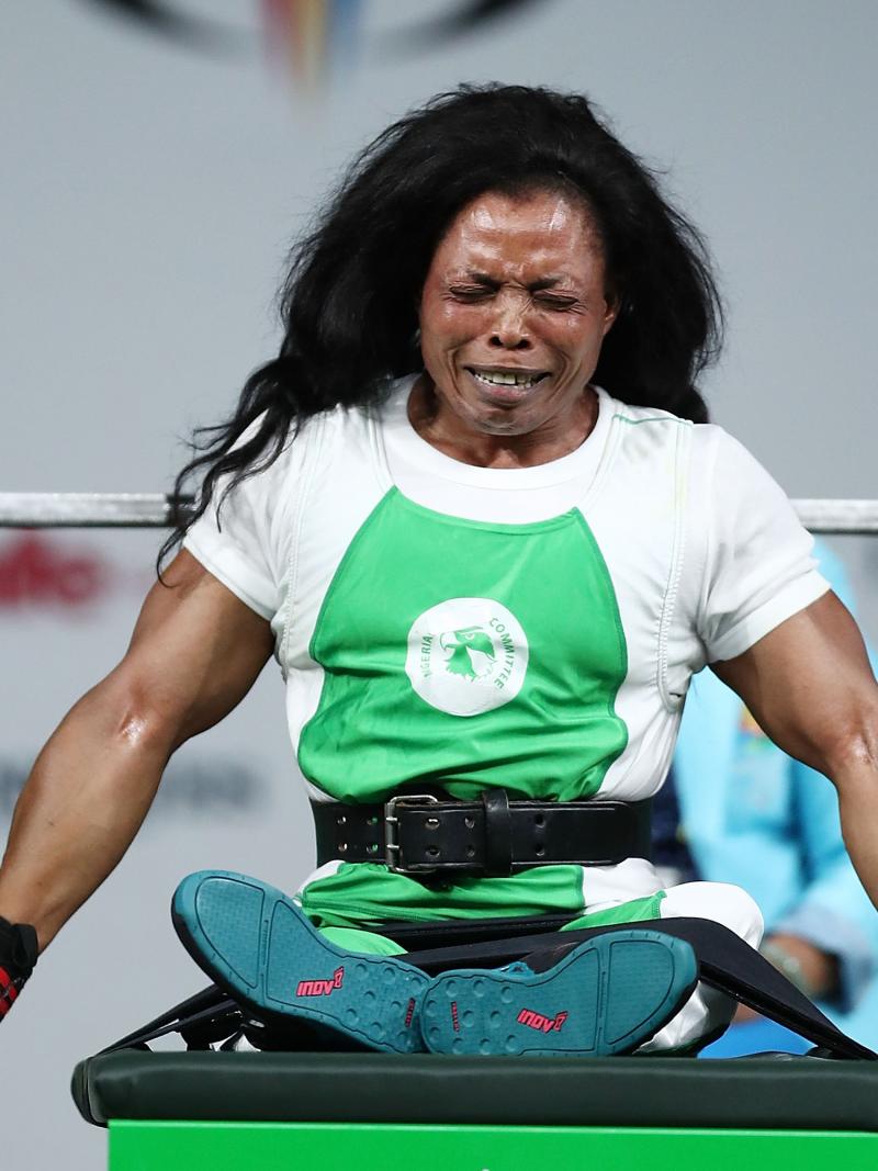 a female powerlifter celebrates on the bench