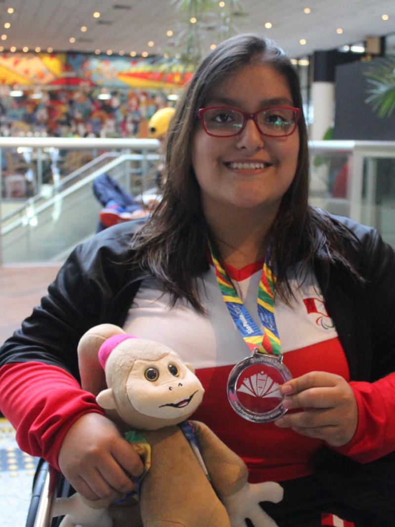 a female Para swimmer with her medal