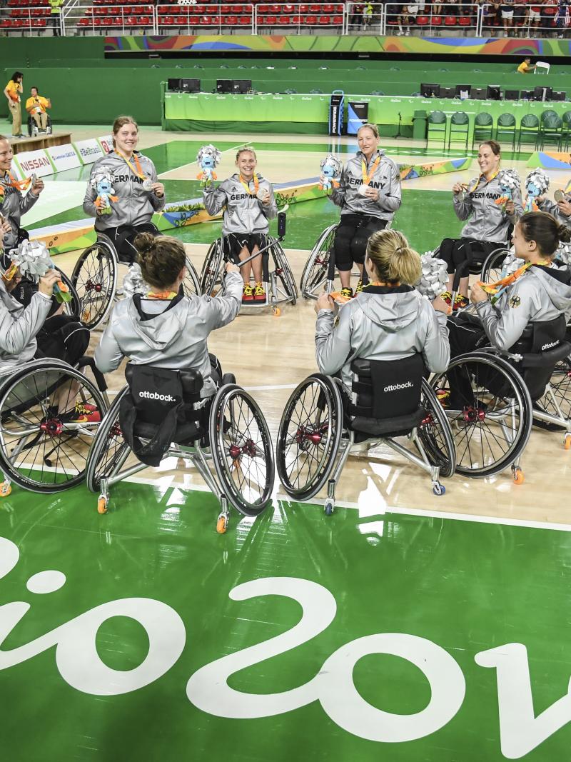 A group of female wheelchair basketballers in a circle