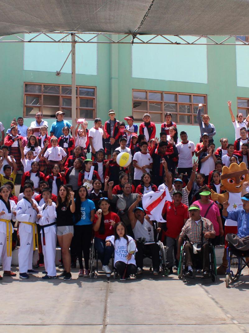 a group of Para athletes and schoolchildren