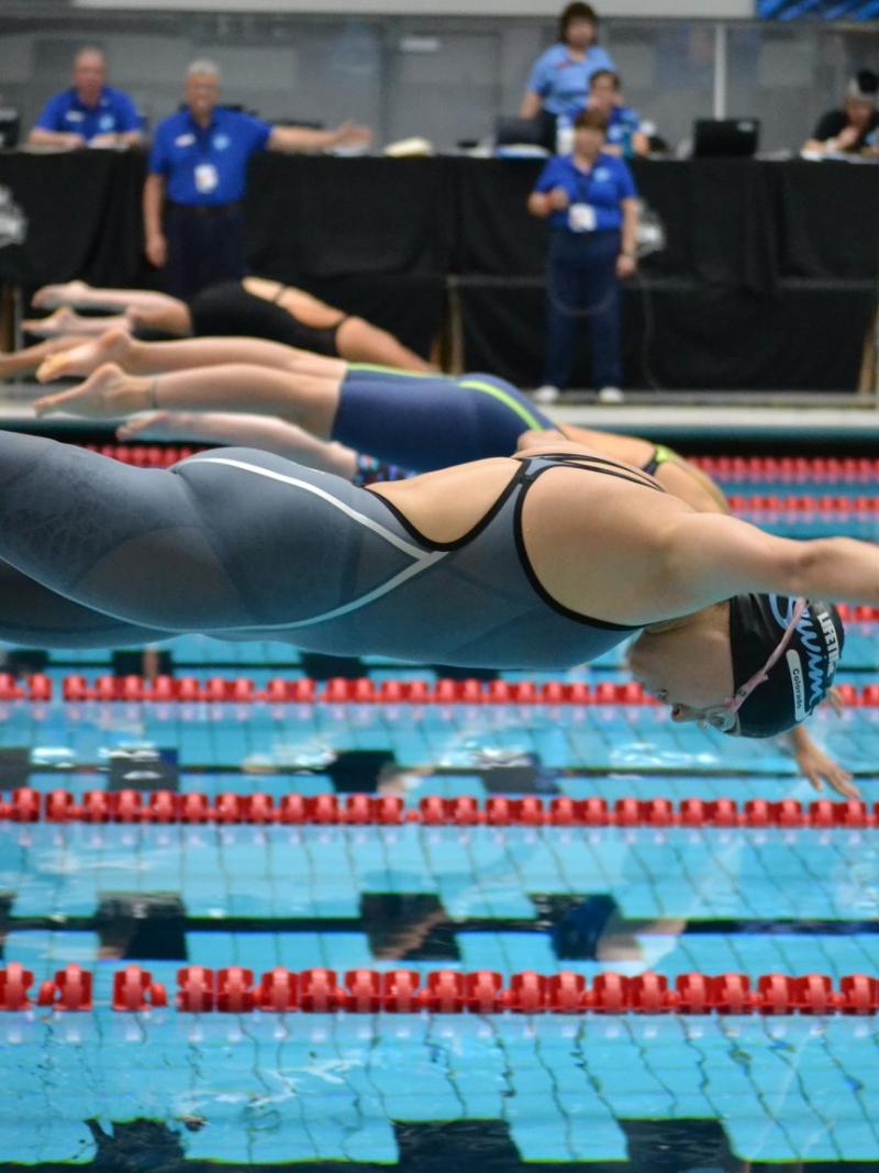 Women swimmers on the starting blocks