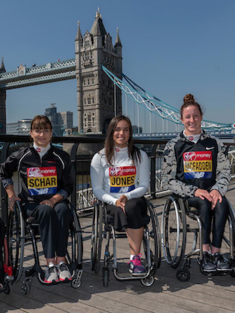 Five athletes in wheelchairs pose for pictures with London's Tower Bridge behind them