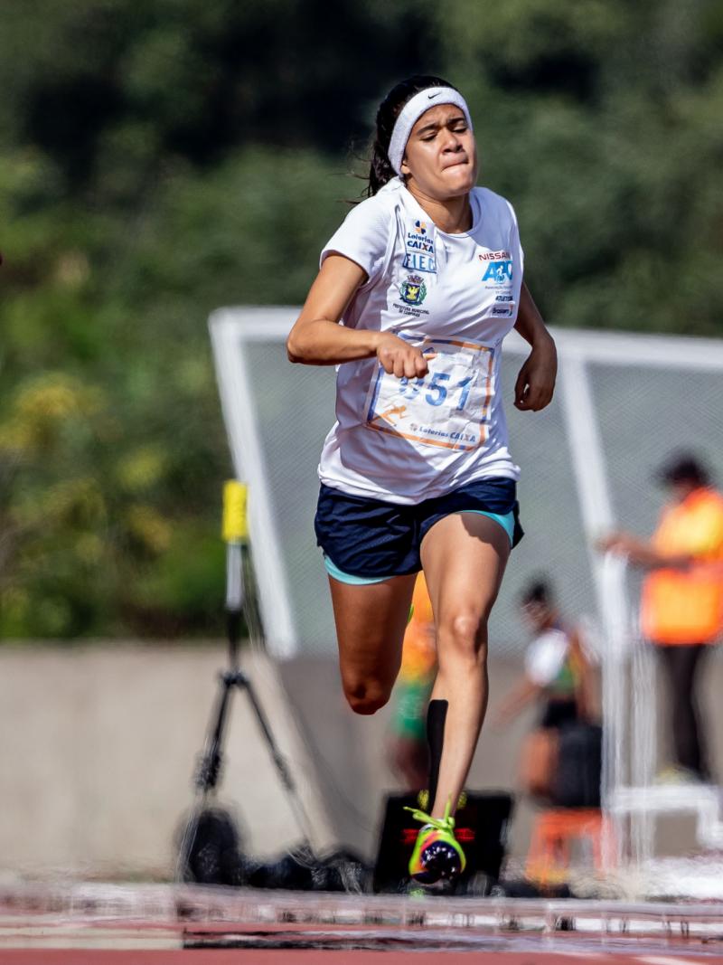 a female Para sprinter runs for the line