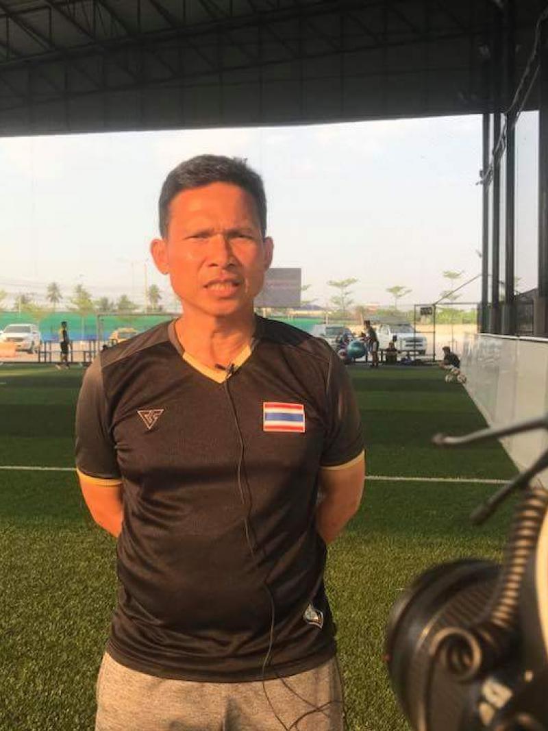 a man standing in front of a football pitch