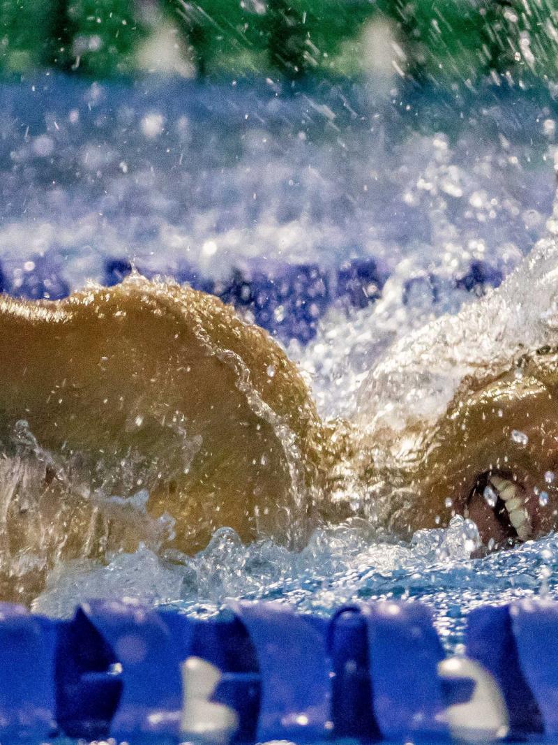 a male Para swimmer mid-freestyle stroke