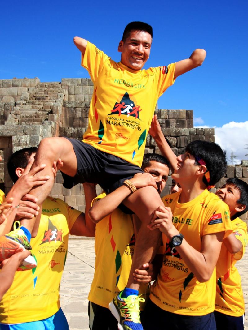 a Para athlete held on the shoulders of other athletes