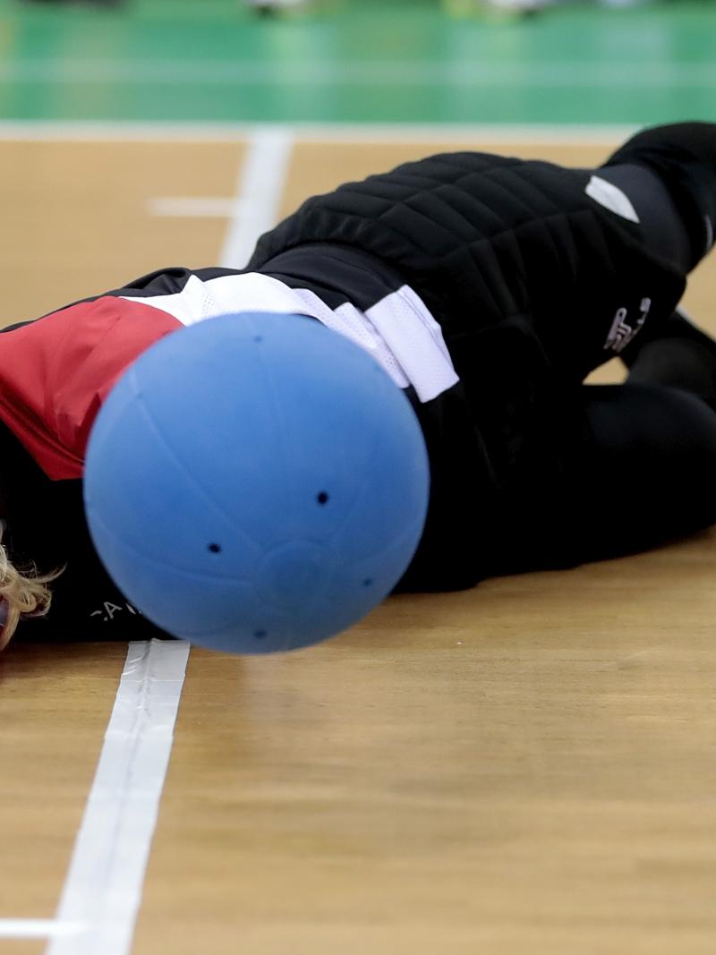 a female goalball player saves a shot
