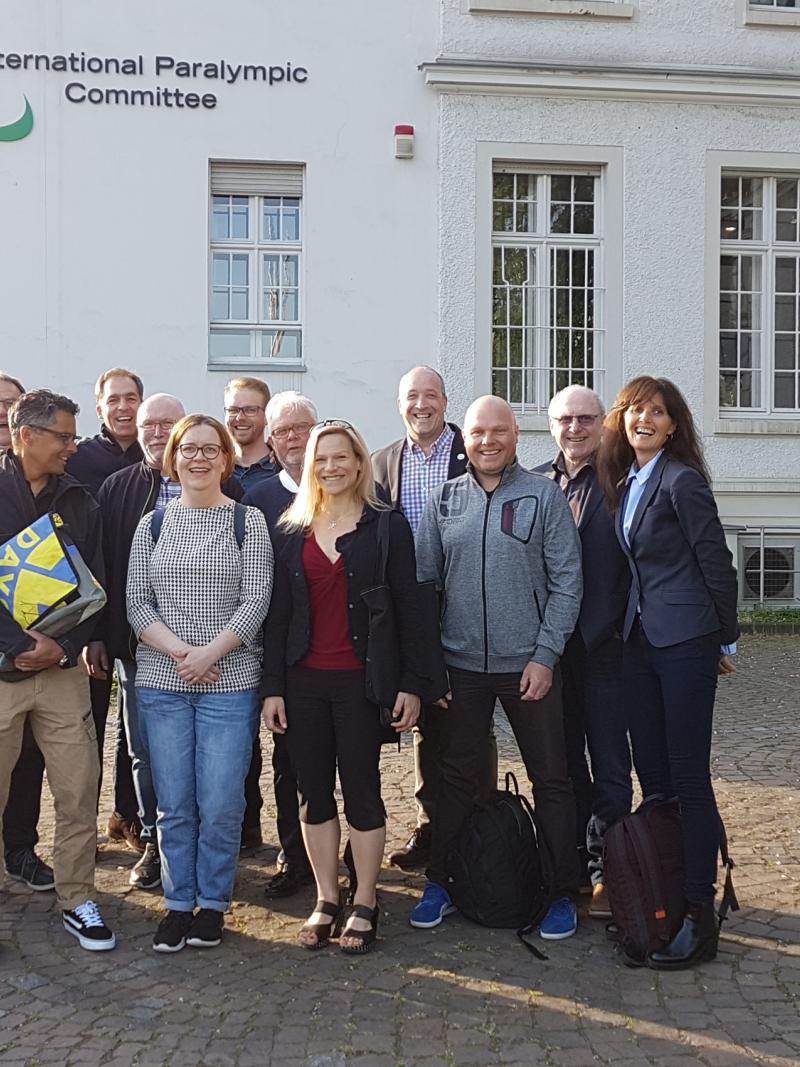 Group of people standing for picture in front of the IPC headquarters in Bonn