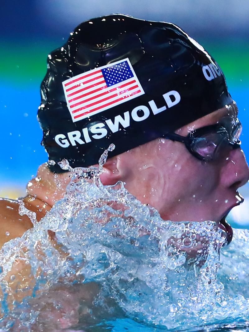 a male Para swimmer mid breaststroke