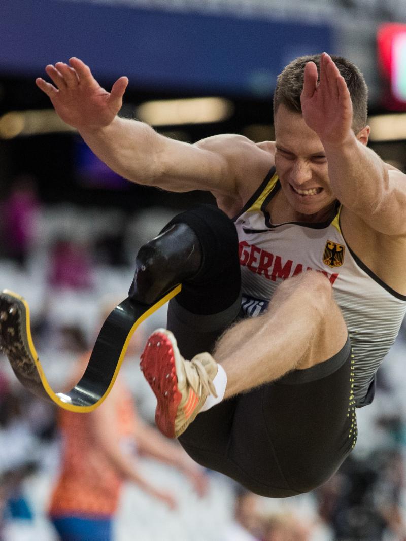 a male Para athlete mid long jump