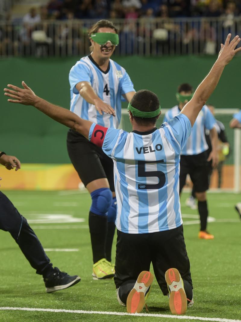 a blind footballer celebrates on his knees