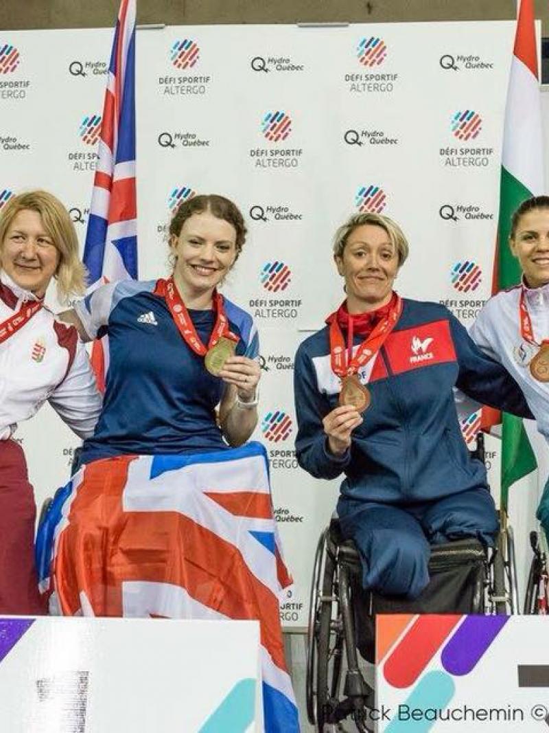 a group of female wheelchair fencers in a row
