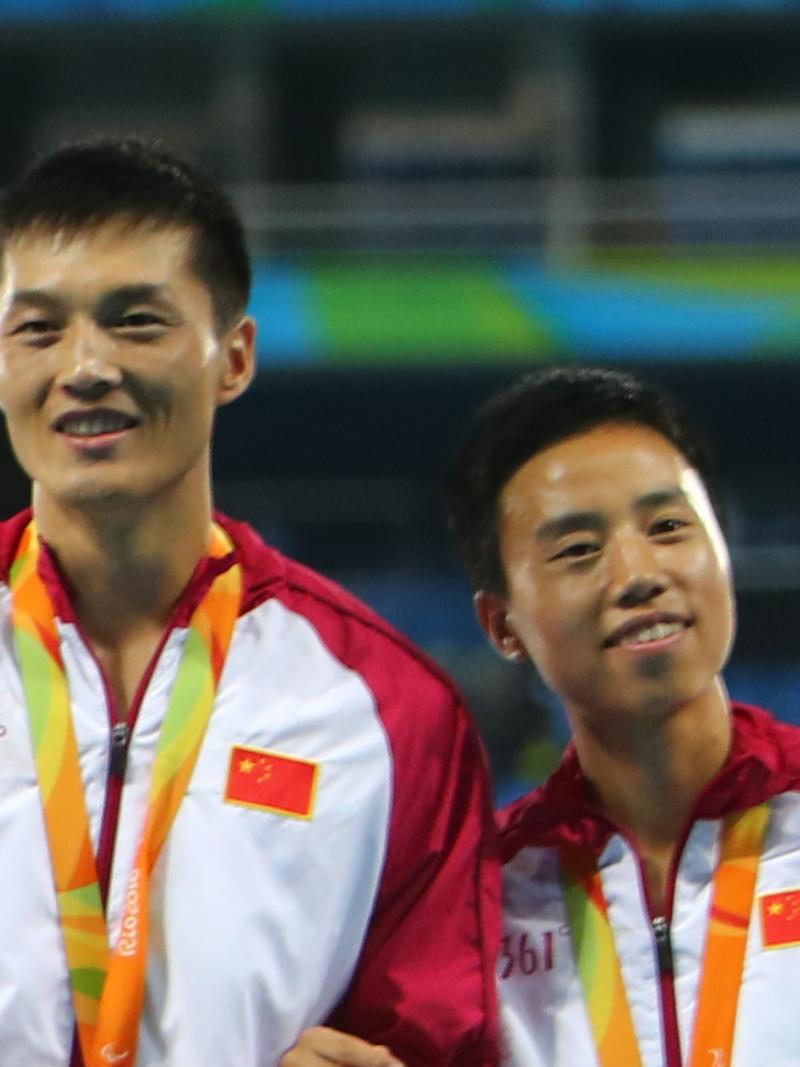 a female vision impaired athlete and her male guide on the podium