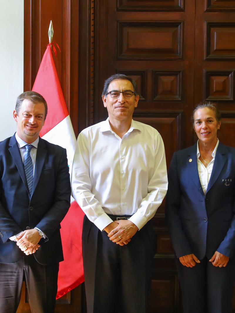 four men and a woman lined up for a photo