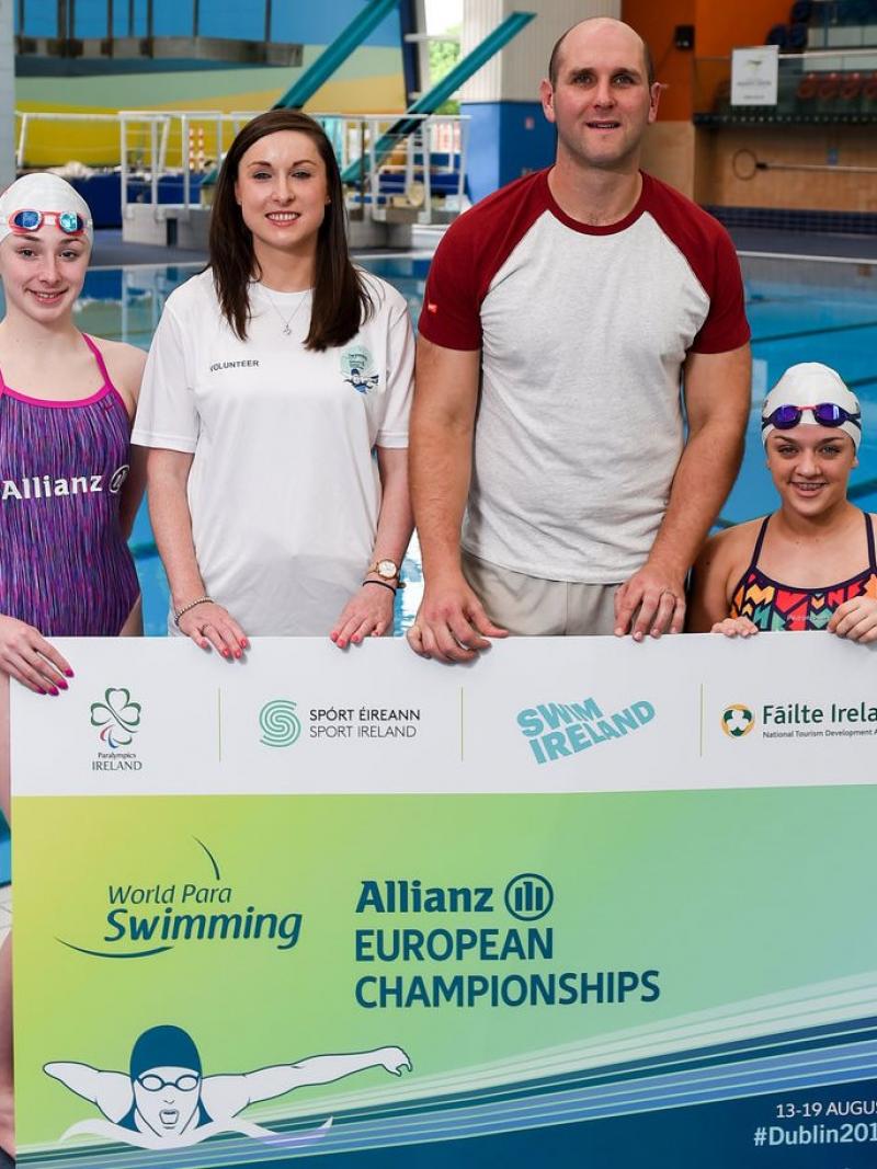 Four people standing showing a big ticket for the Dublin 2018 Para Swimming Euros