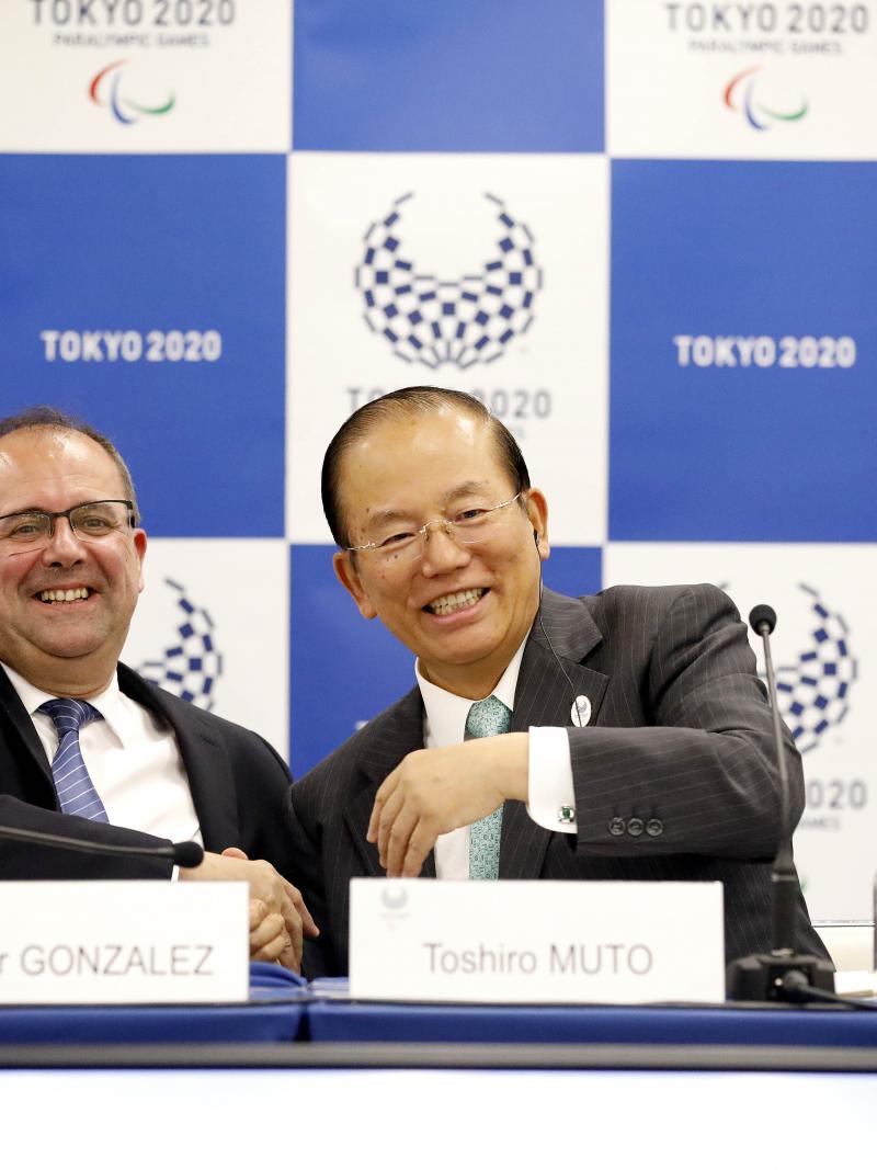 two men smiling and shaking hands