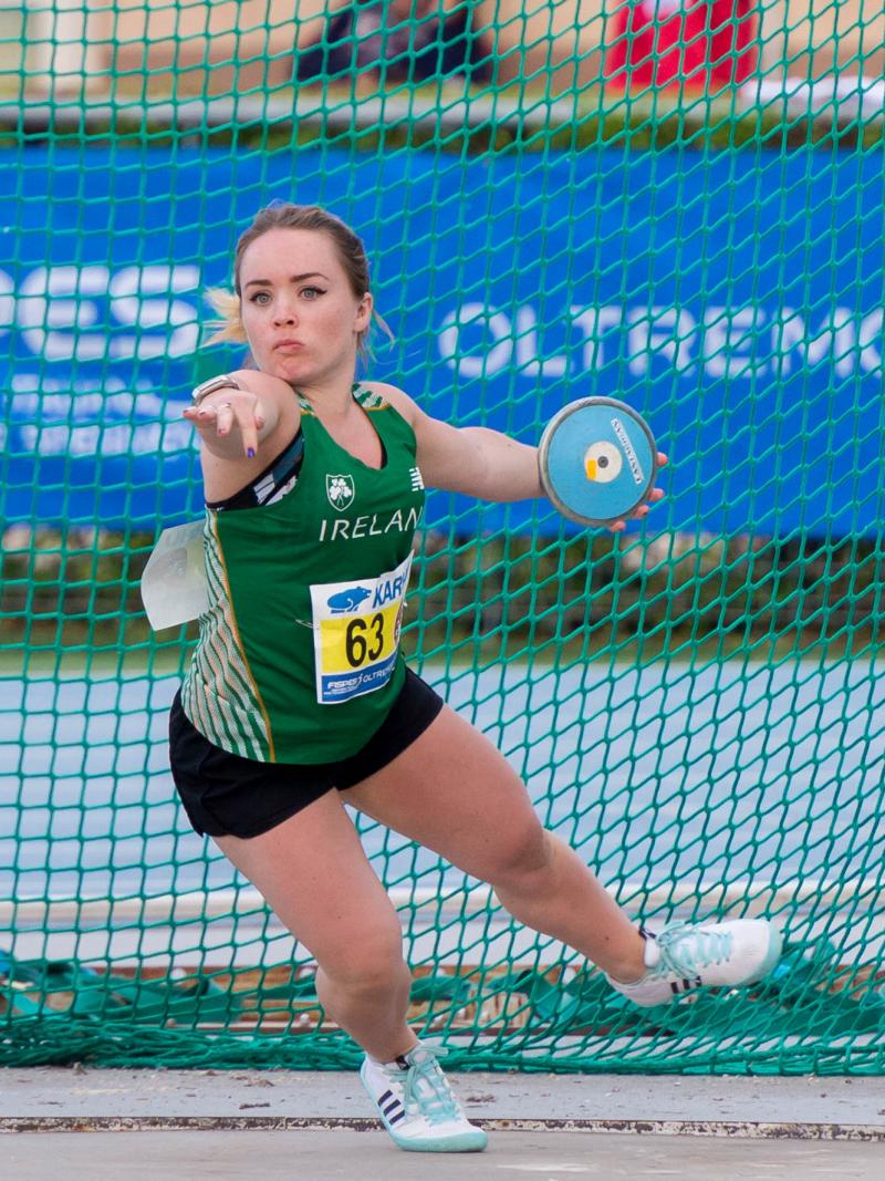 Short statured female discus thrower competing 