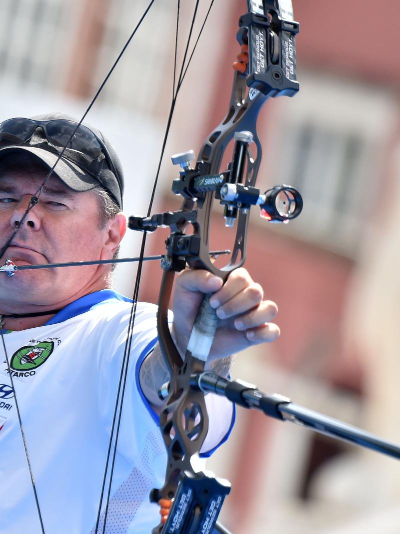a male Para archer prepares to shoot an arrow
