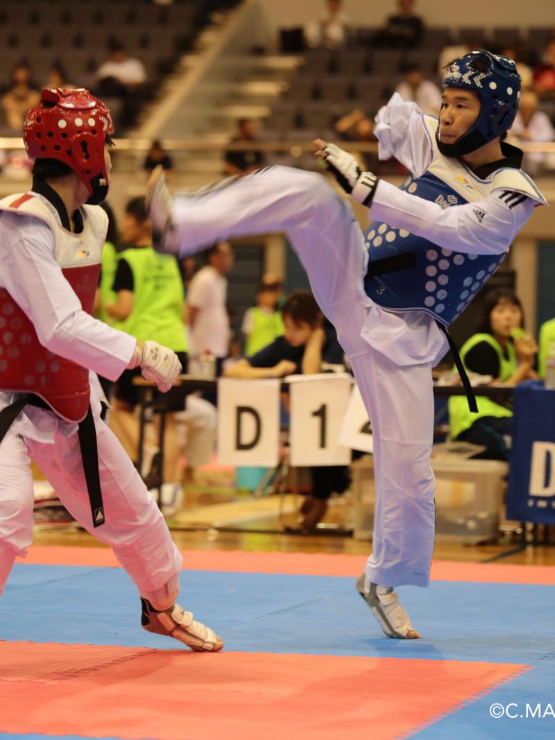 two male taekwondo fighters face off