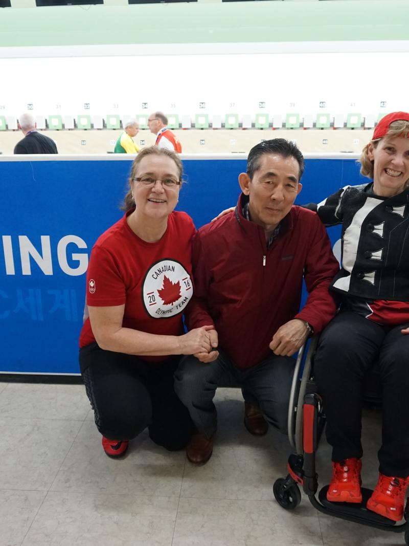 a female Para shooter hugs and smiles with her former coach