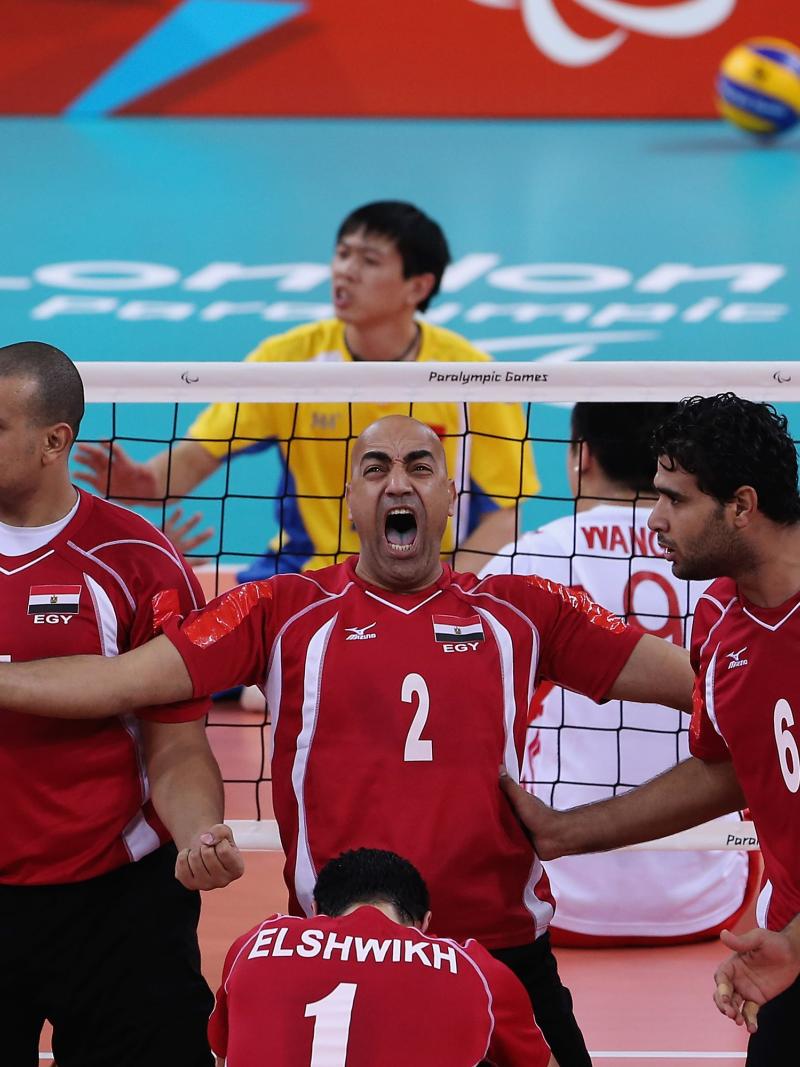a men's sitting volleyball celebrate and shout on the court