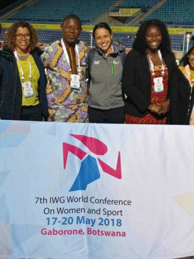a group of women standing behind a flag