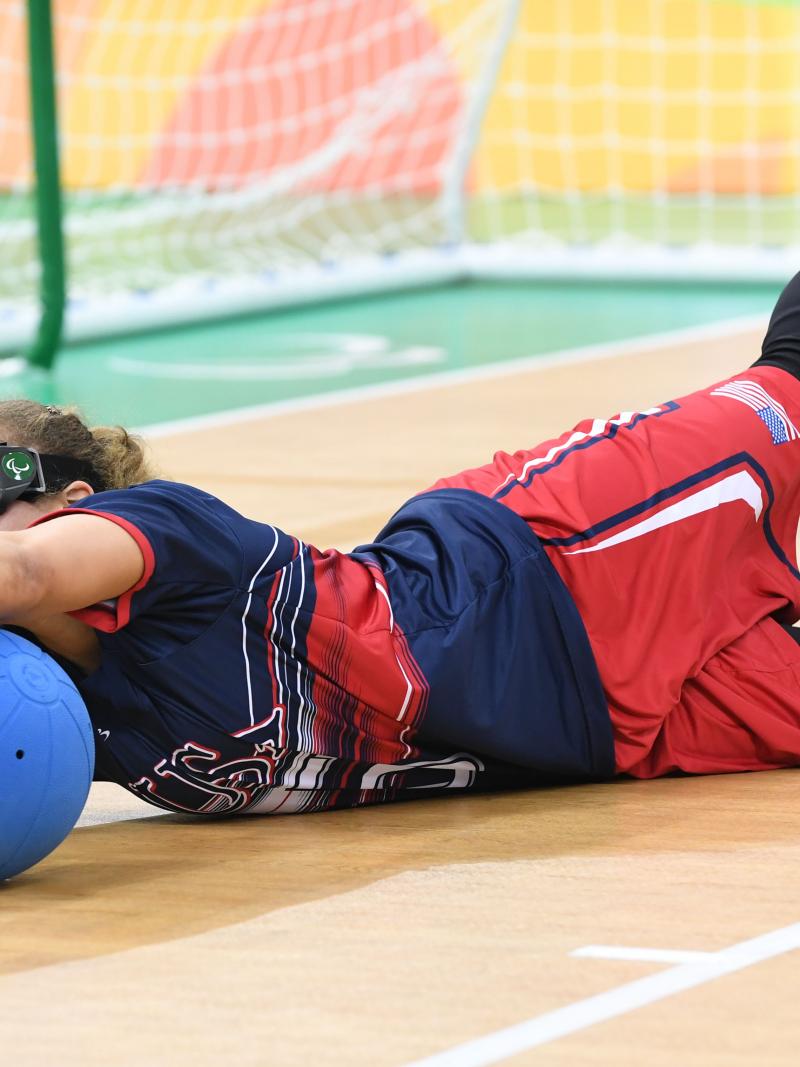 a female goalball player saves a shot
